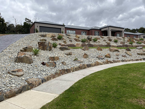 Well constructed landscape including rock garden turf and path